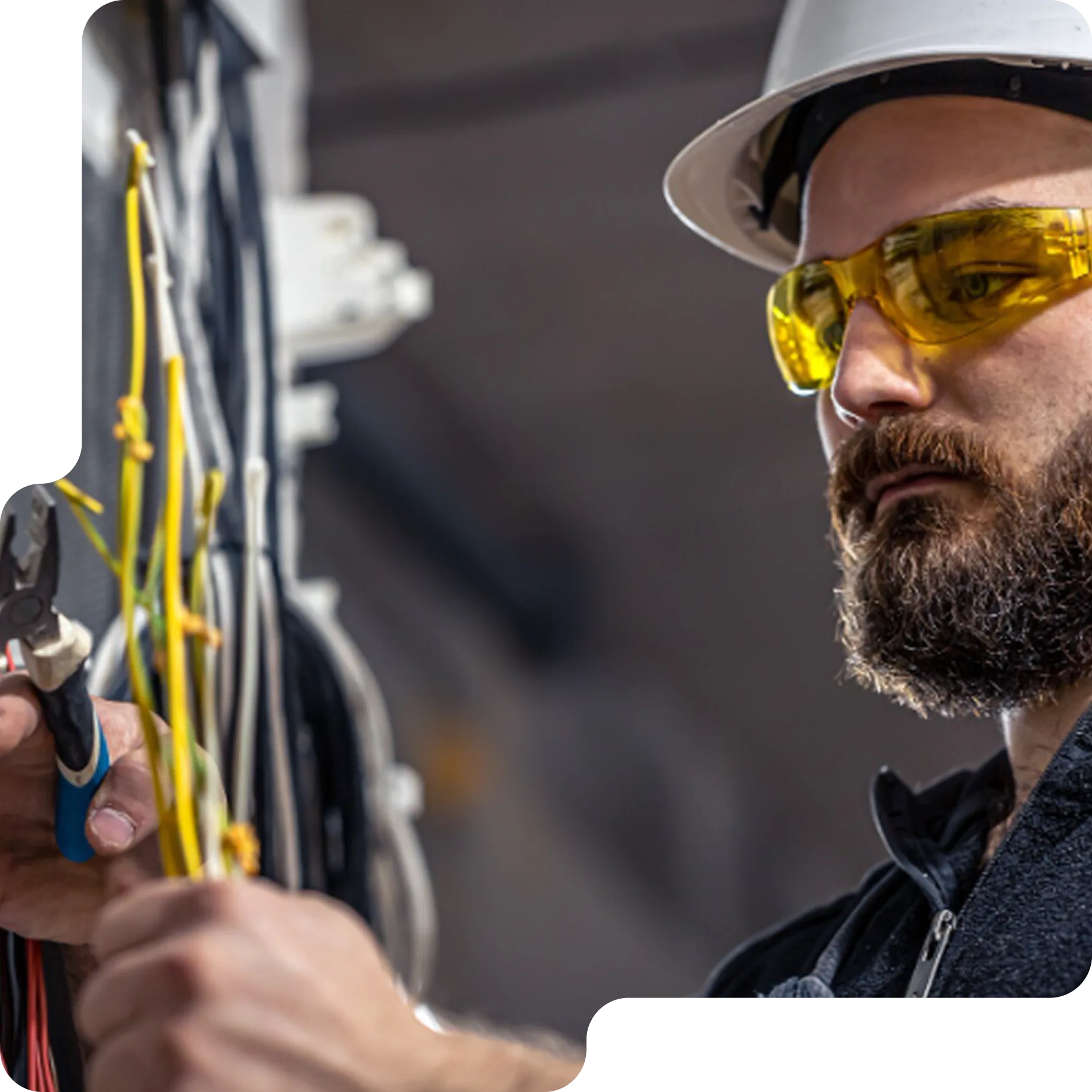 Electrician handling exposed electrical wires during a repair or installation.