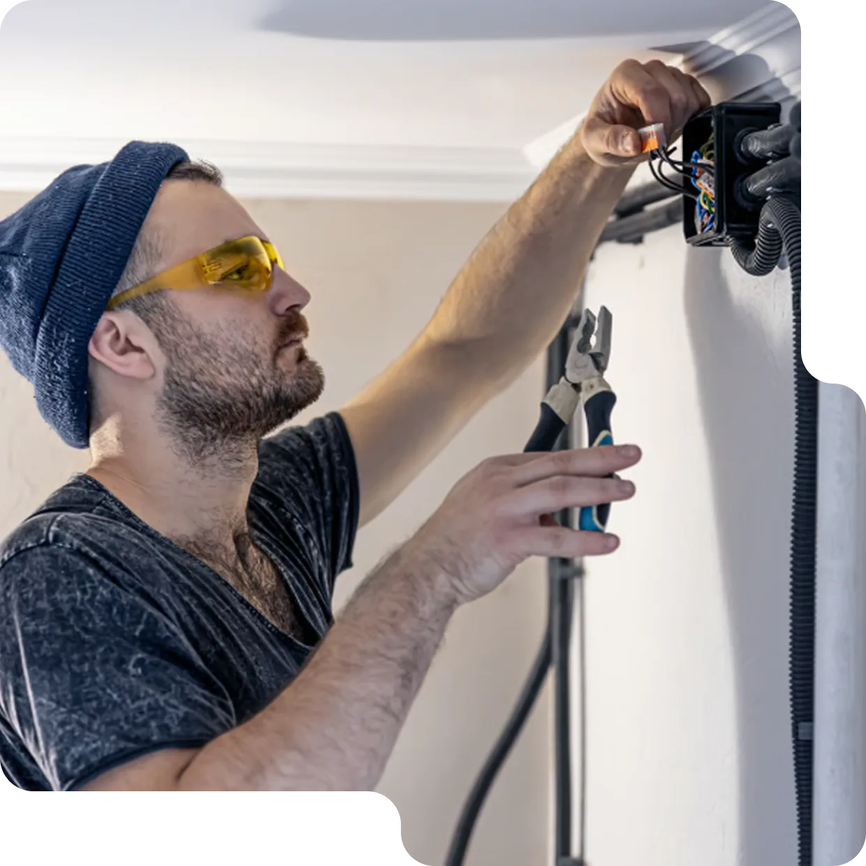 Friendly LampPost electrician carrying a step ladder and tool bag through a residential hallway