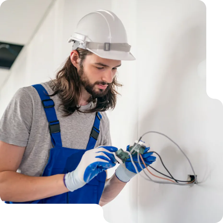 A happy homeowner consulting with a friendly LampPost electrician during a light fixture installation.