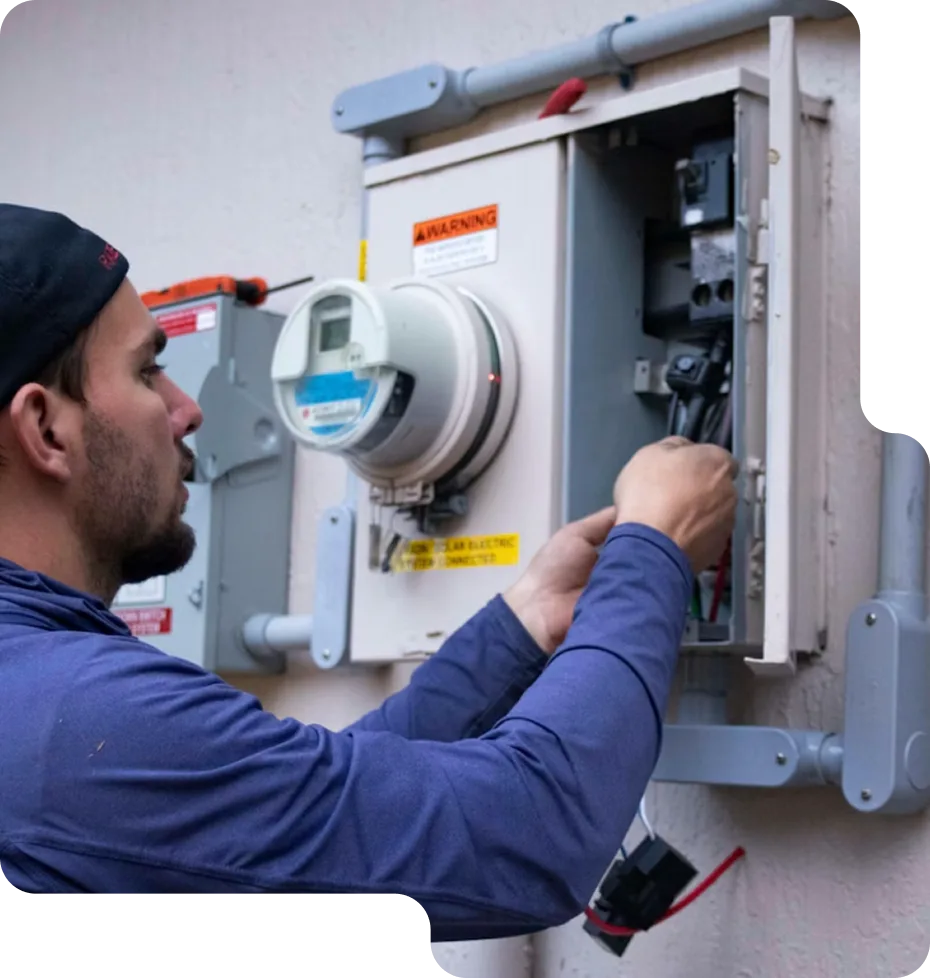 A happy homeowner consulting with a friendly LampPost electrician during a light fixture installation.