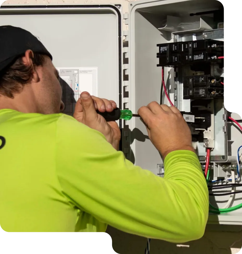 A happy homeowner consulting with a friendly LampPost electrician during a light fixture installation.